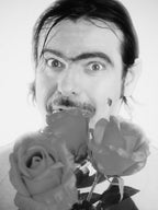 Black and white photo of a person holding roses with a neutral background